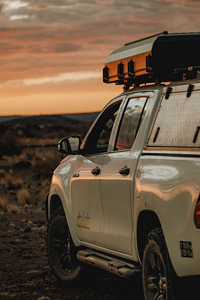 Toyota Hilux 4x4 Rental Car in Namibia with rooftop tent at sunset