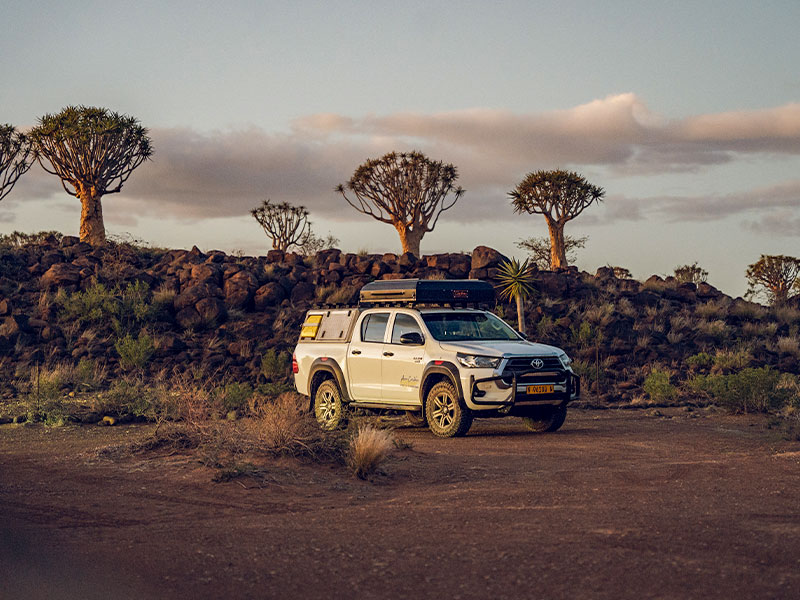Asco Toyota Hilux off-road in Characteristic Namibiam Landscape with Quiver Trees