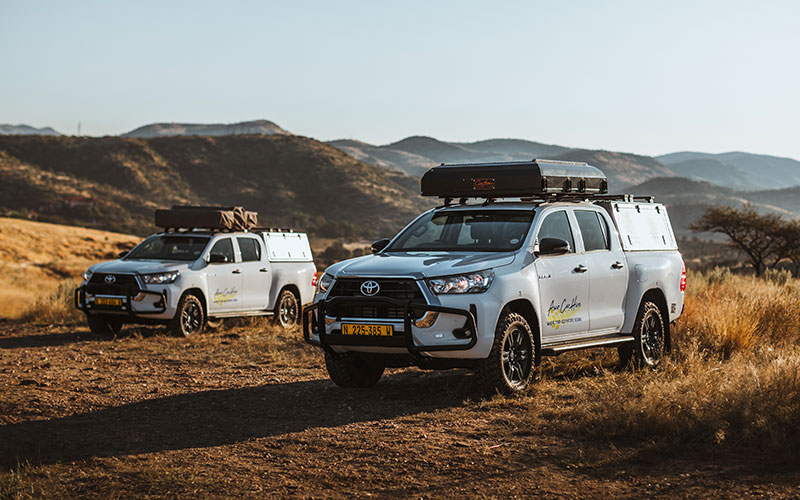 Two Asco Toyota Hilux 4x4 Car Rental with Rooftop Tents in Namibia Landscape